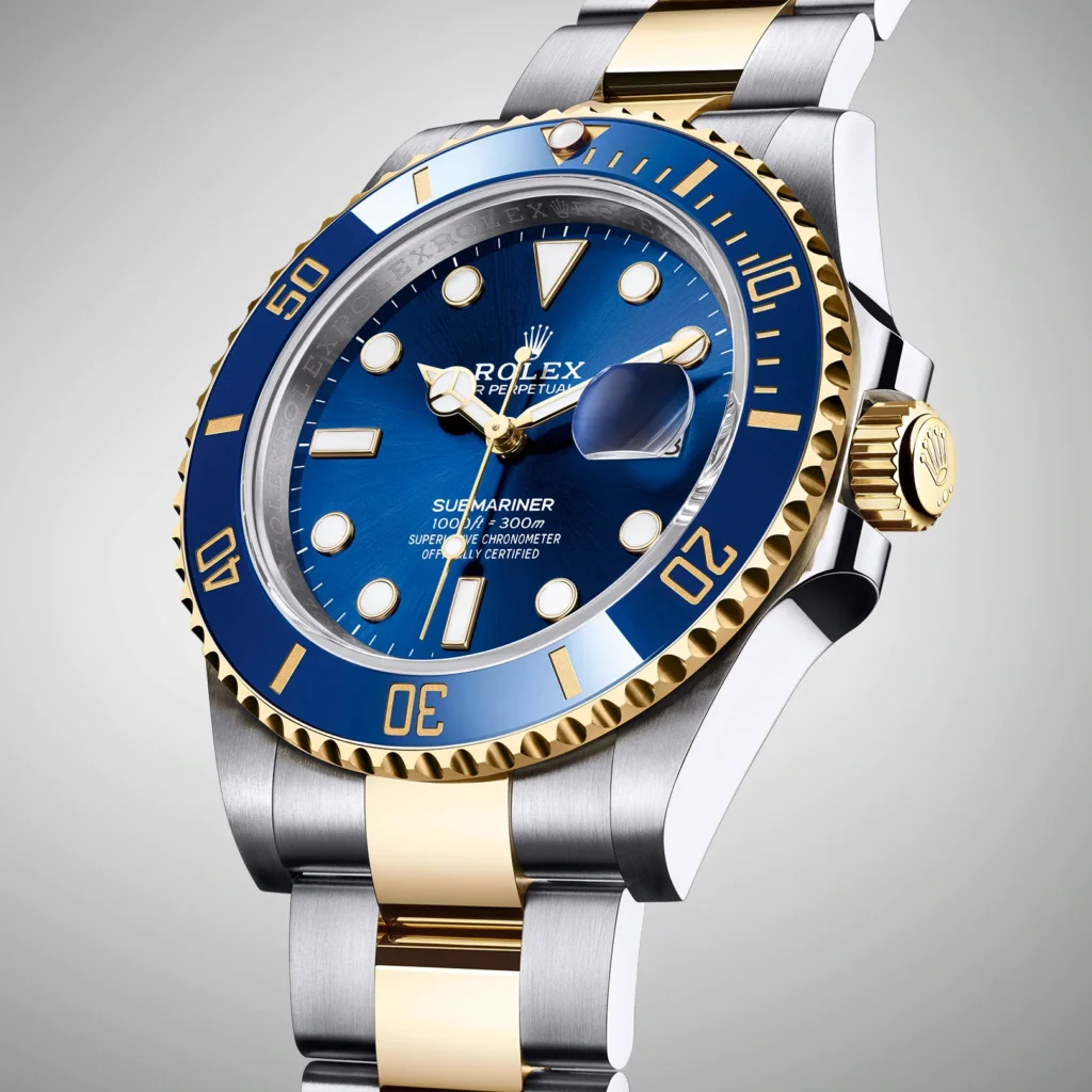 A blue and gold rolex watch is on the wrist.