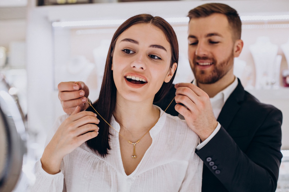 A man and woman are fixing their hair.